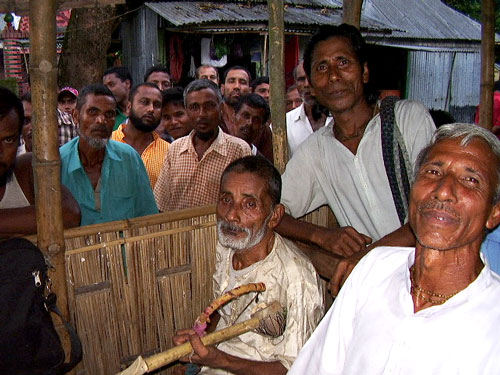 Villagers and folk music­ians gather in leisure time for some music and relaxation in remote area of Rajarhaat (Bangladesh)