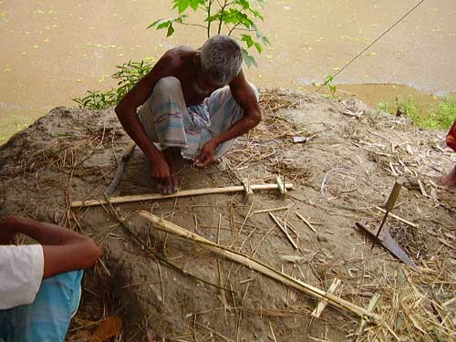 Bangladeshi crane trapper preparing his fand or trap